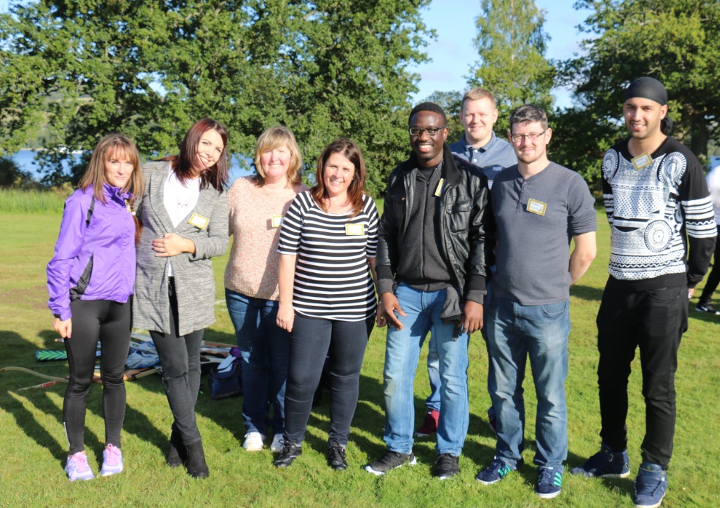 A group posing outdoors on a lawn during the BT Exemplar recognition trip