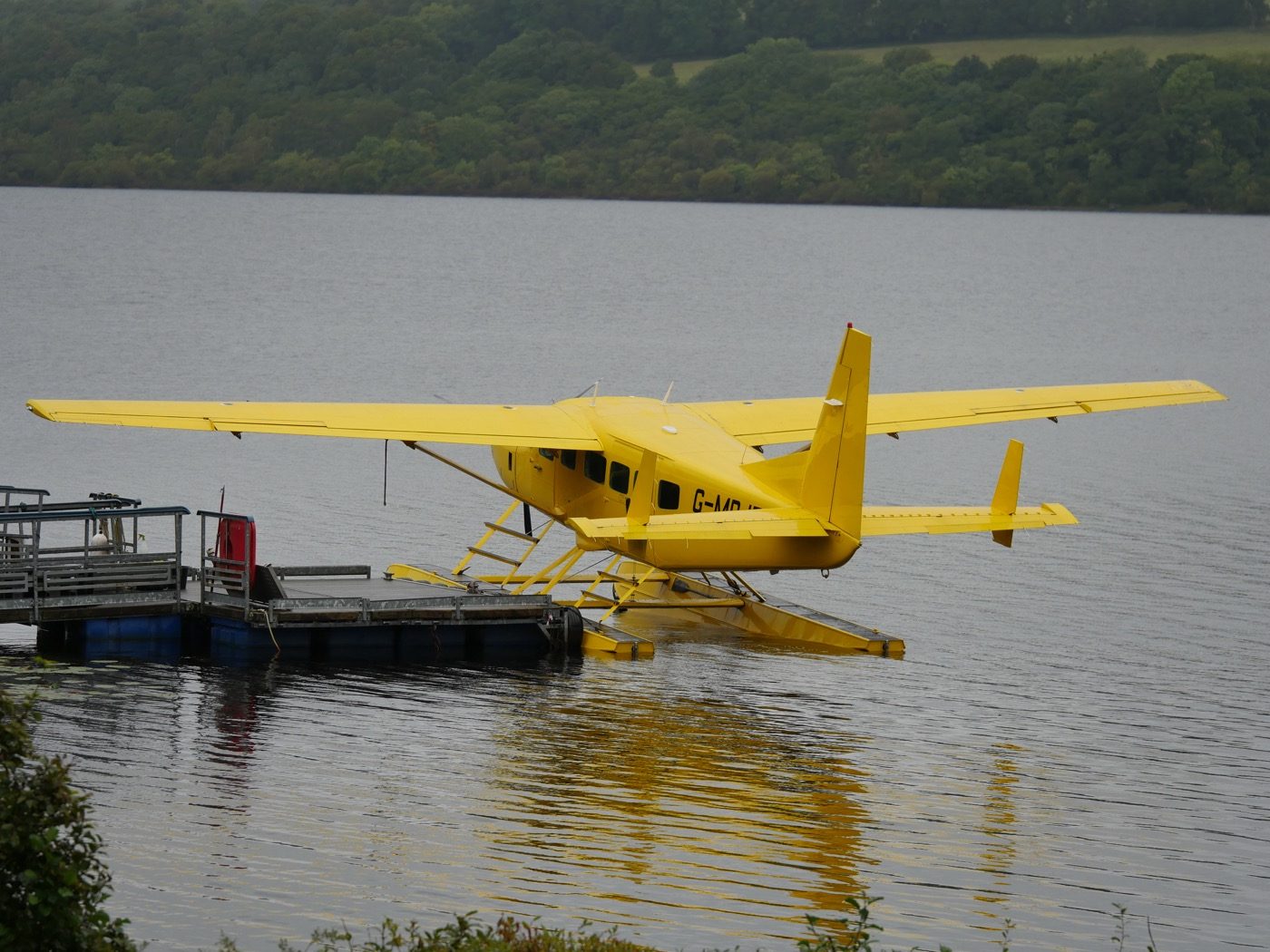 A yellow seaplane moored on Loch Lomond